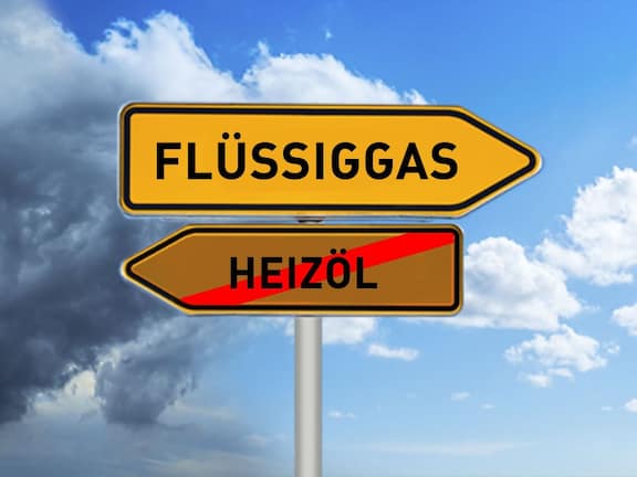 Two-yellow-opposite-arrow-direction-signs-away-from-heating-oil-in-the-direction-liquefied-gas-with-sky-background