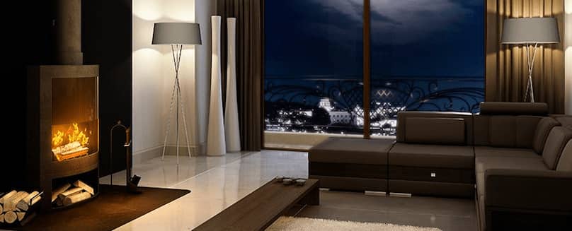 Heizen mit Flüssiggas - TEGA GmbH Ein-Ofen-in-einem-Zimmer-mit-Couch-und-Lampen-mit-Aussicht-auf-die-Stadt-bei-Nacht